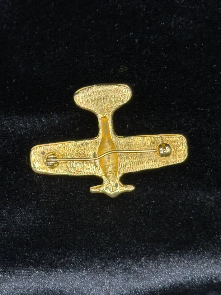 Gold-tone stylized airplane brooch with clear rhinestone accents on the wings, view 4