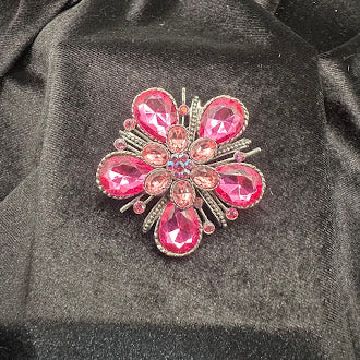 Silver-tone flower brooch with pink teardrop crystal petals and radiating bars, view 2