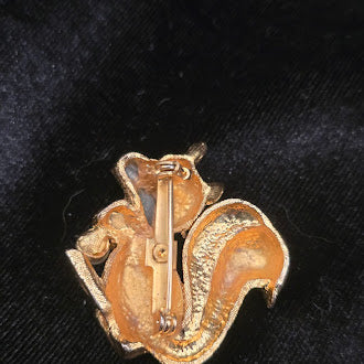 Gold tone squirrel brooch with rhinestone acorns and faux pearl detail