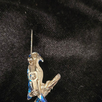 Gold-tone parrot brooch with blue enamel perched on a branch with long tail, view 4