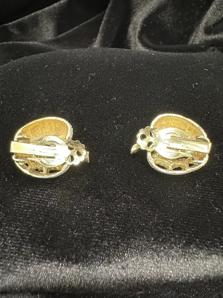 Gold-tone textured basket clip earrings filled with green faceted crystals, view 2