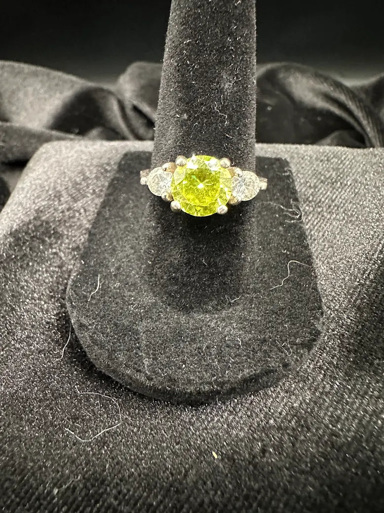 Silver-tone three stone ring with round lime green center and clear side stones, size 6.75, view 2
