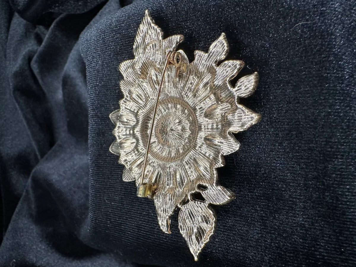 Sunflower brooch with yellow marquise crystal petals, amber center and green and teal crystal leaves, view 4
