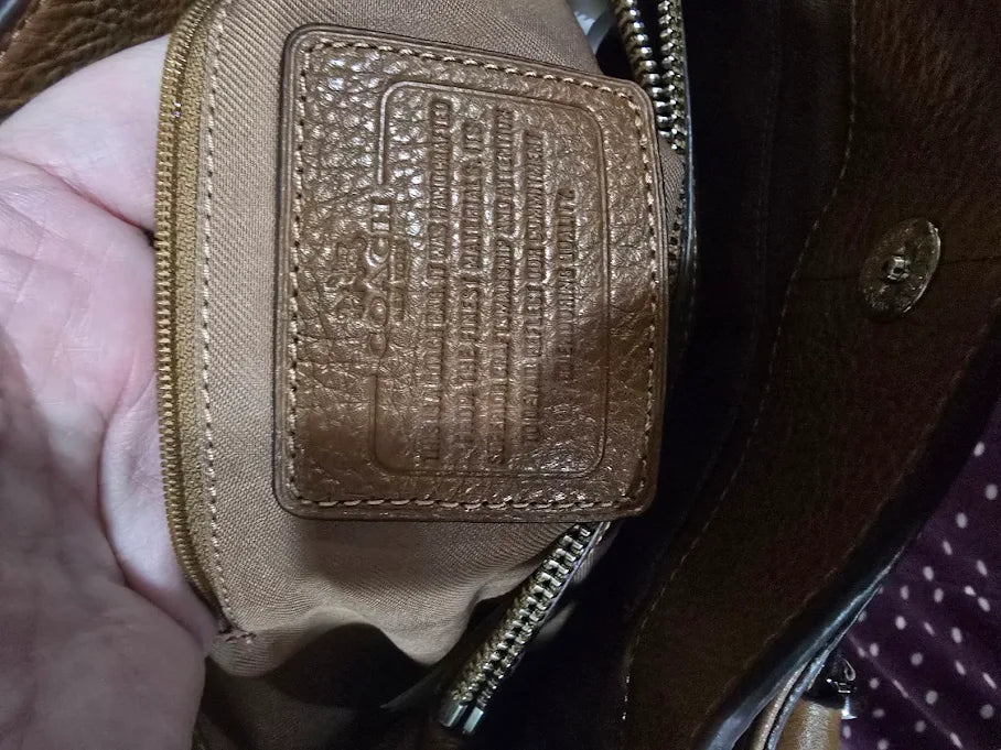 Brown pebbled leather carryall satchel with rolled handles and crossbody strap, view 6