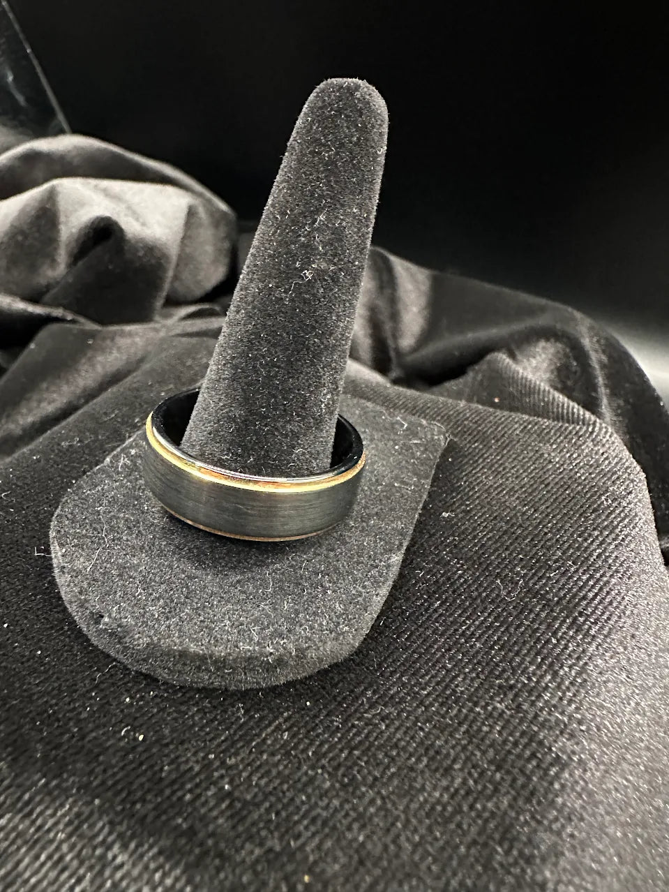 Men's wedding band with brushed black exterior and gold-tone interior, listed as tungsten, view 3
