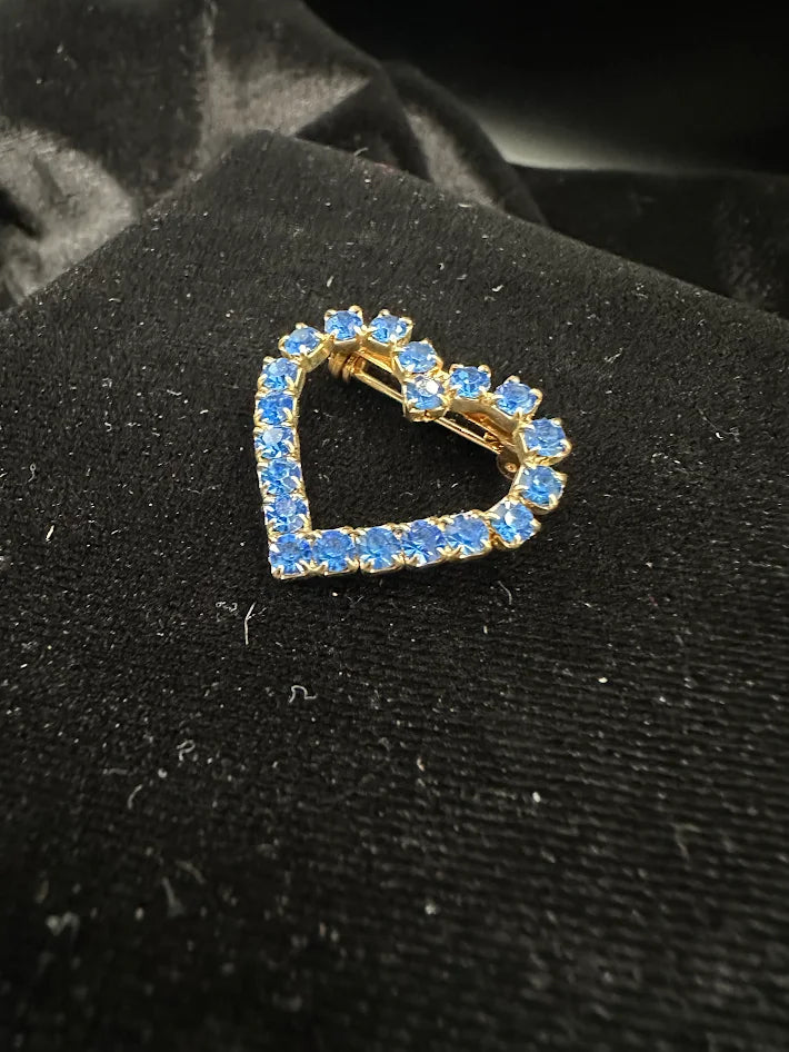 Gold tone open-heart brooch with blue rhinestones