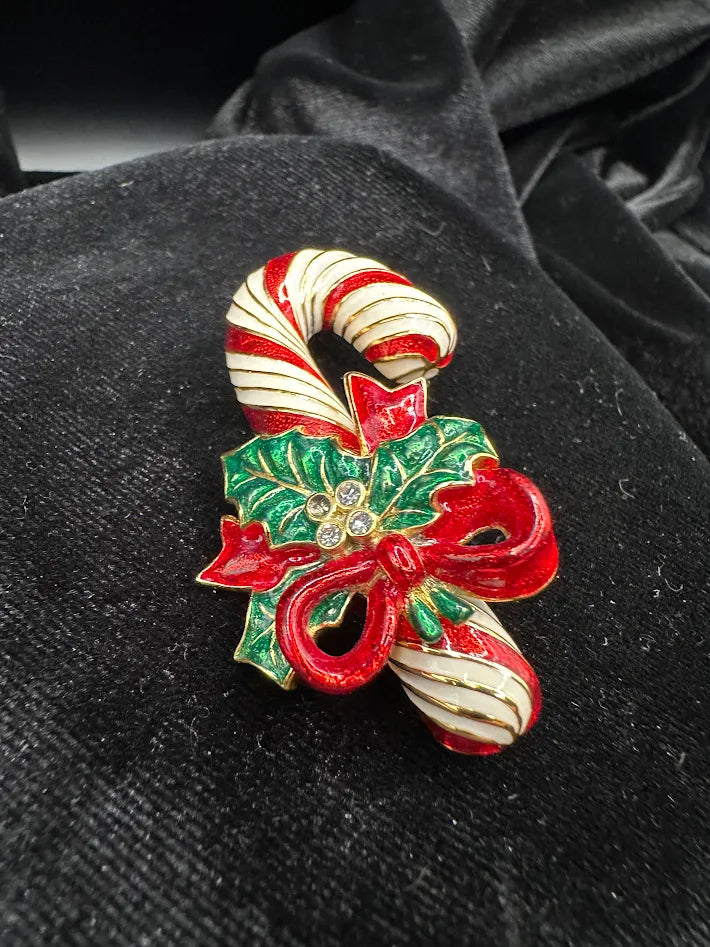 Red and white enamel candy cane Christmas brooch with green holly, red bow and clear stones, view 3