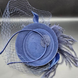 Blue felt pillbox hat with net veil and feather spray