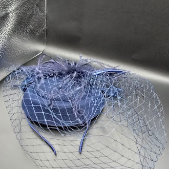 Blue felt pillbox hat with net veil and feather spray