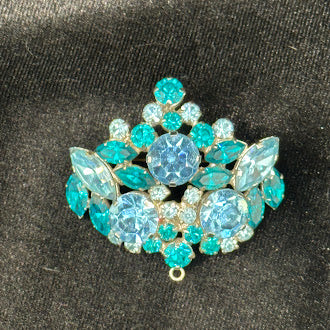 Silver-tone brooch pendant marked Austria with light blue and teal rhinestones, view 4
