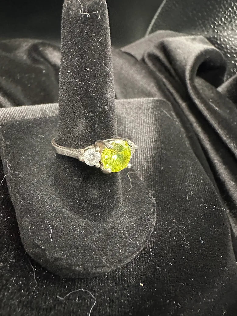 Silver-tone three stone ring with round lime green center and clear side stones, size 6.75, view 4