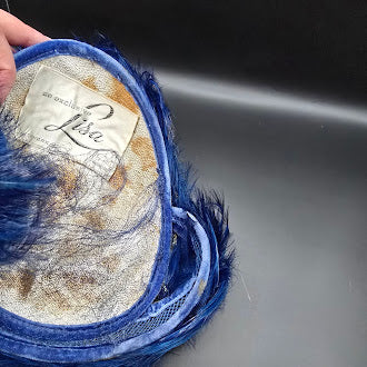 Lisa New York blue feather hat with net trim