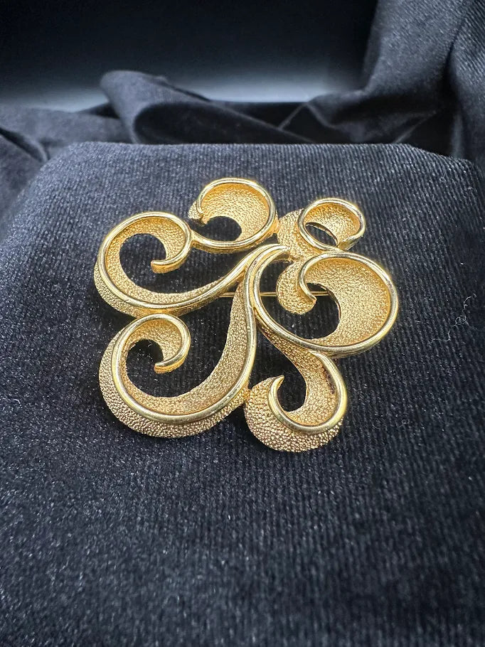 Signed Trifari gold-tone openwork scroll brooch, view 4