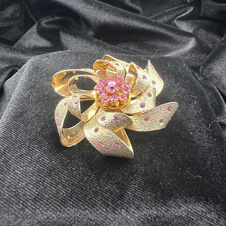 Gold-tone pinwheel brooch of textured ribbon swirls with pink crystal cluster center, view 2