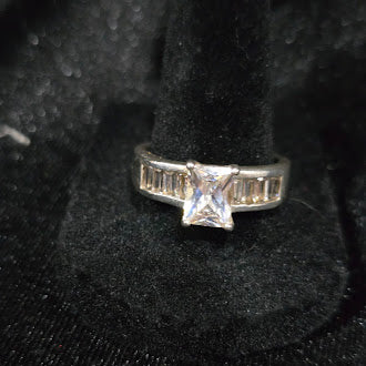 Silver ring marked 925 with princess-cut cubic zirconia center and baguette shoulder accents, view 2