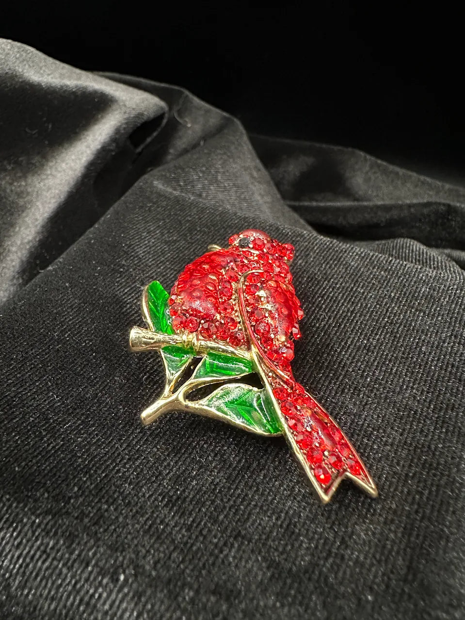 Gold-tone cardinal bird brooch with red crystal body and green enamel-style leaves, view 5