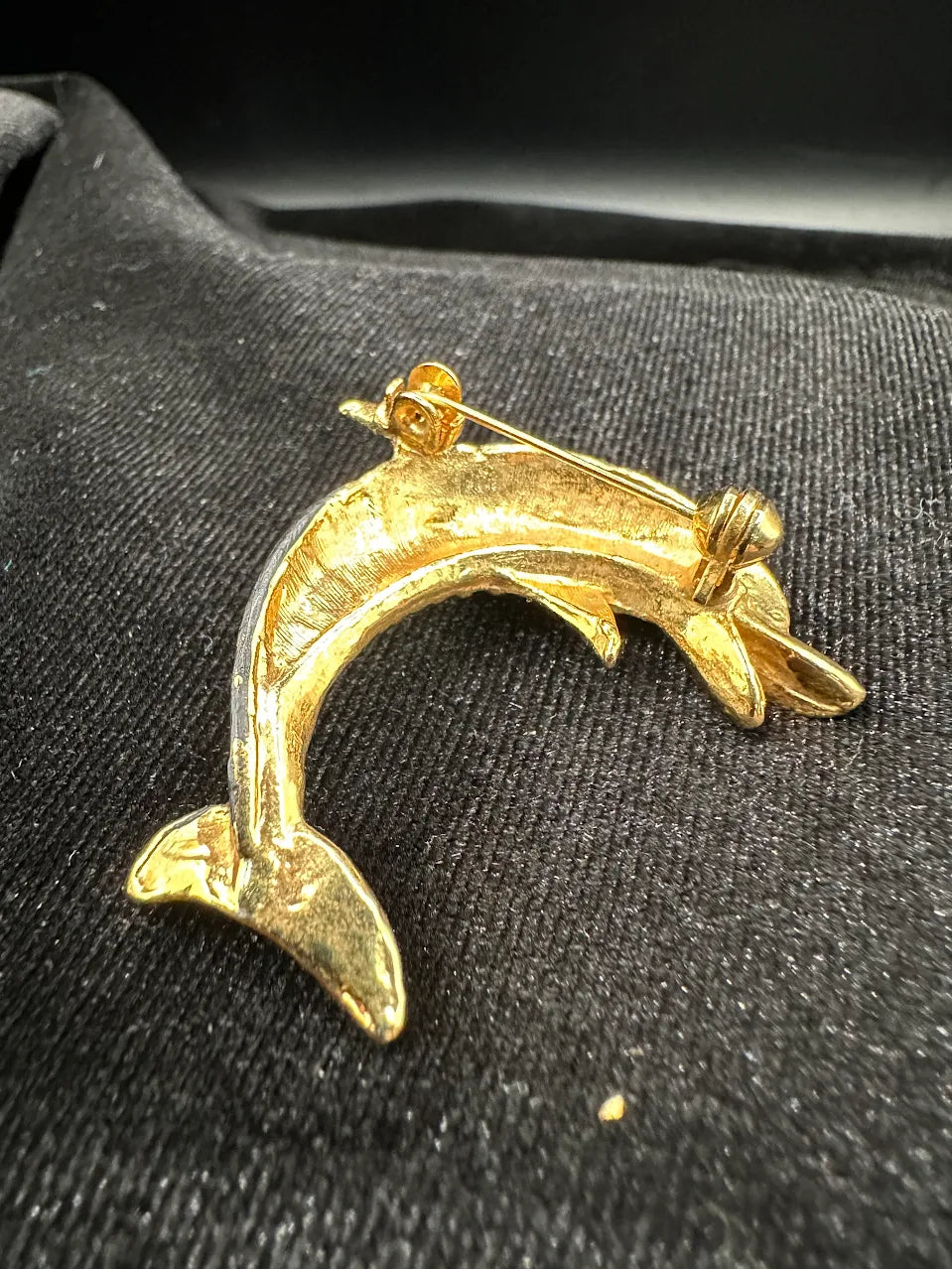 Gold-tone leaping dolphin brooch with gray body and clear crystal accents, view 5
