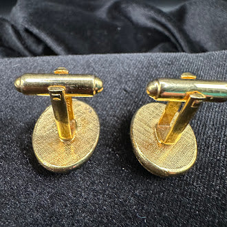 Gold-tone oval cameo-style cufflinks with raised light figure on dark ground, view 6