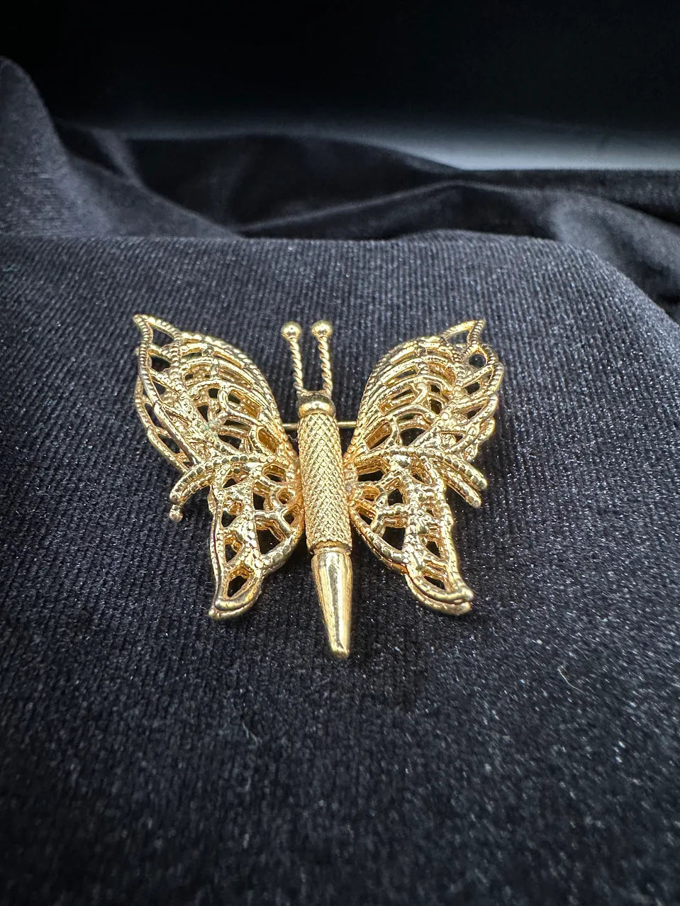 Signed Monet gold-tone openwork butterfly brooch with textured filigree-style wings, view 2