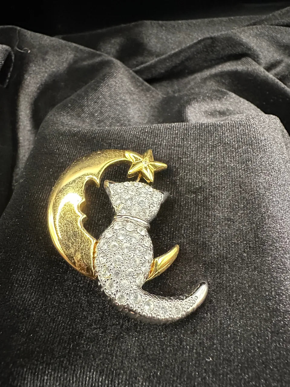 Two-tone brooch of a clear crystal cat on a gold-tone crescent moon with star, view 2