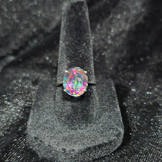 Ring marked 925 with oval faceted rainbow iridescent stone in a four-prong setting, view 2