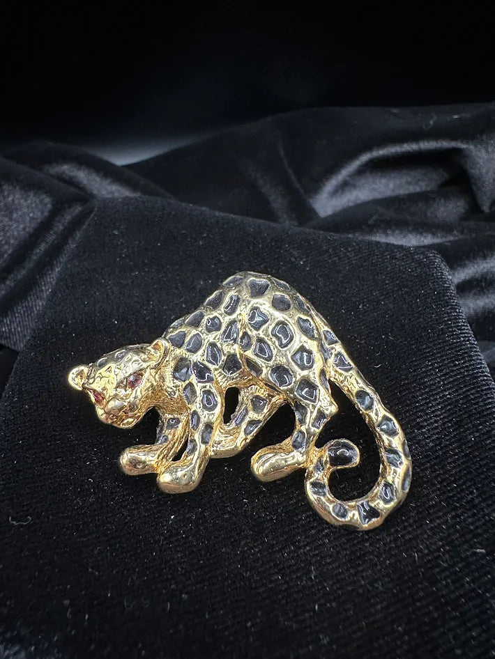 Gold tone leopard brooch with black enamel spots and red eye accent