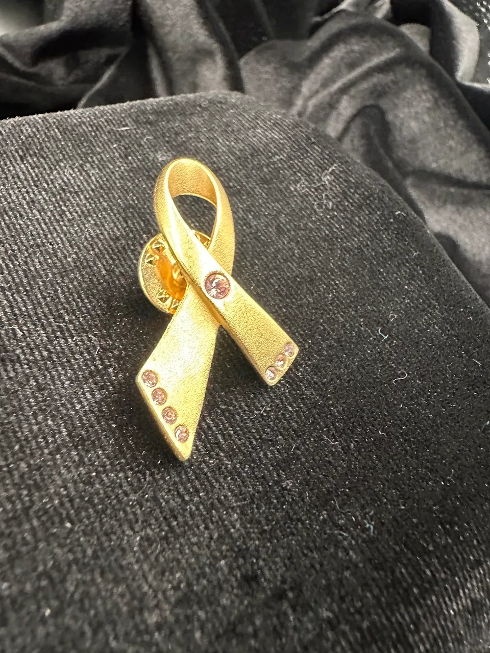 Avon Gold Tone Pink Crystal Ribbon Brooch with Textured Awareness Ribbon Design