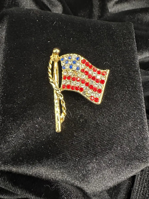 (PULL MISSING STONES) Gold tone American flag brooch with red white and blue rhinestones