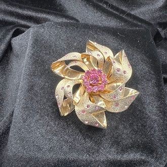 Gold-tone pinwheel brooch of textured ribbon swirls with pink crystal cluster center, view 3