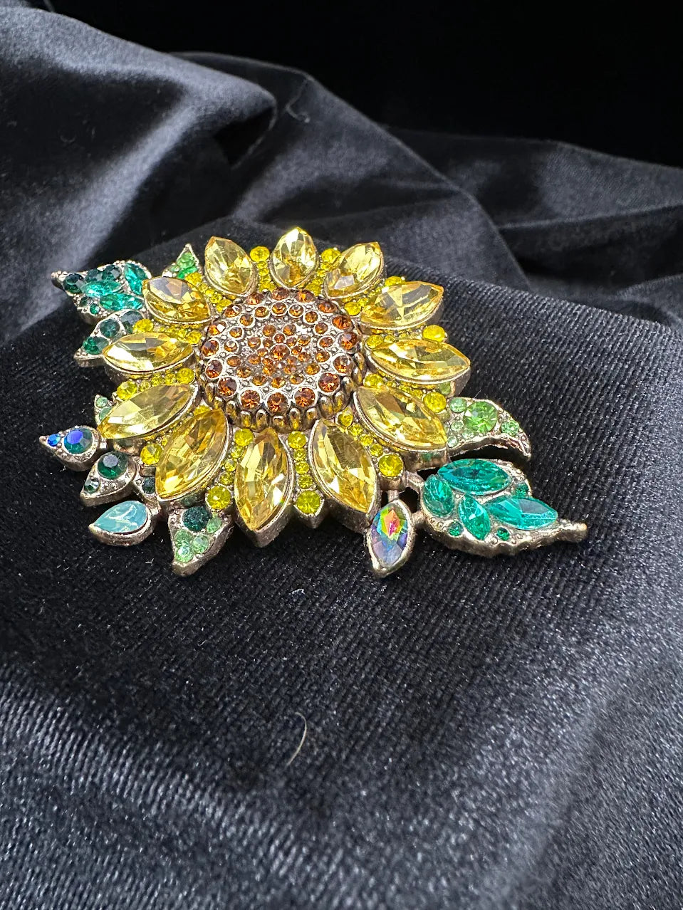 Sunflower brooch with yellow marquise crystal petals, amber center and green and teal crystal leaves, view 3