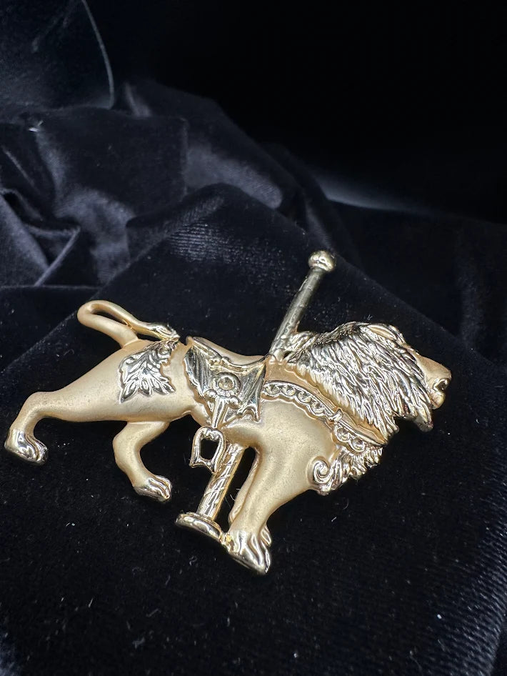 Vintage Enamel Gold tone carousel lion brooch with textured mane and saddle detail