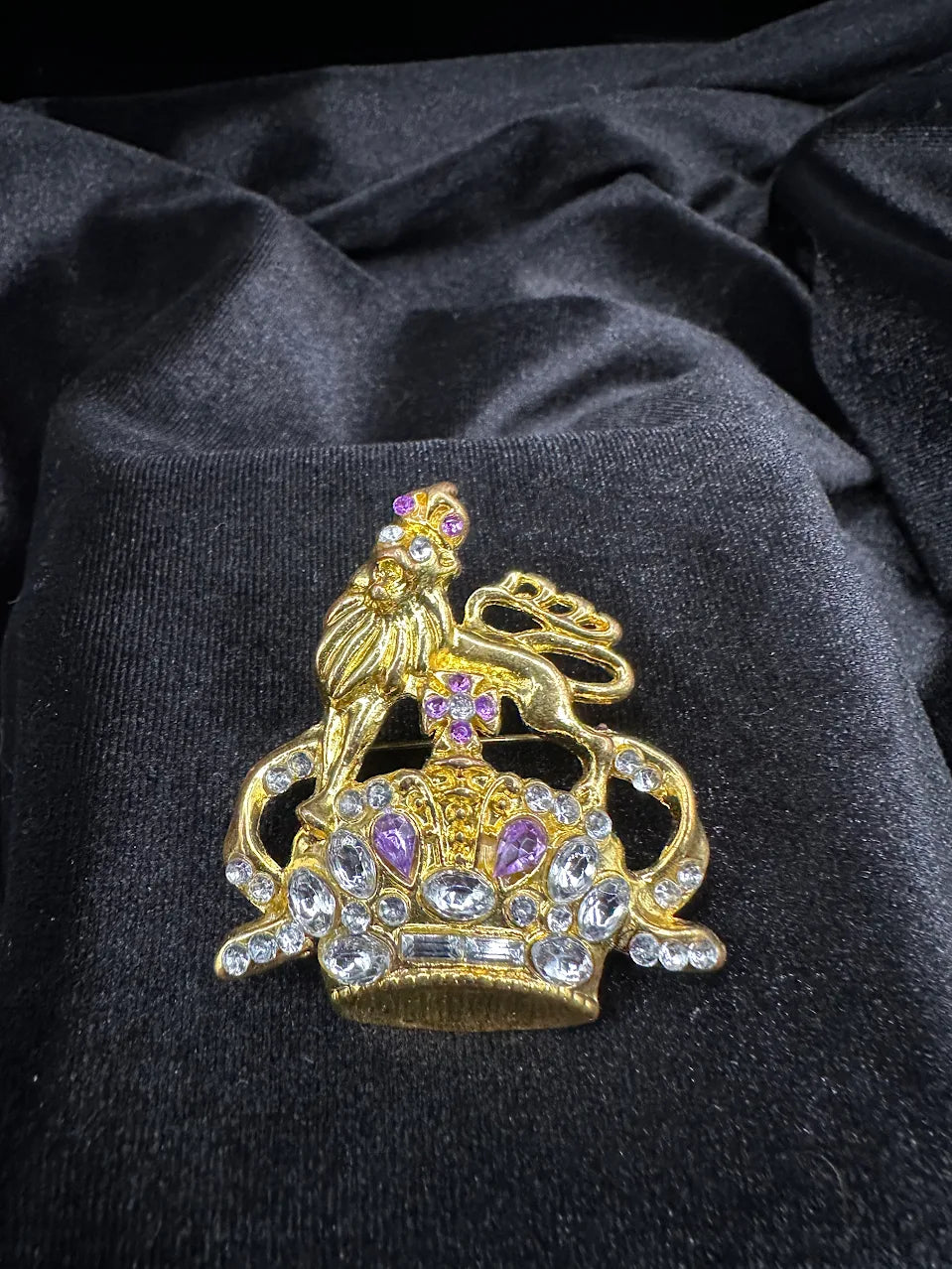 Gold-tone ornate crown brooch topped with a lion, set with clear and purple crystals, view 2