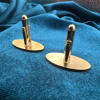 Vintage gold tone oval tie tack set with textured geometric design and chain back