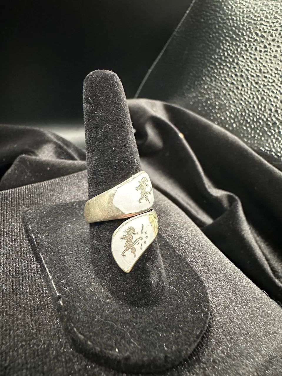 Two-tone silver and gold-tone bypass wrap ring with pale enamel-style panels and etched figures, view 3