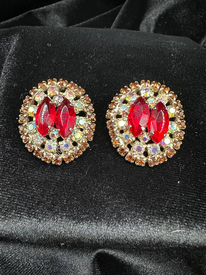 Gold-tone oval cluster clip earrings with red marquise crystals and aurora borealis rhinestone halo, view 4
