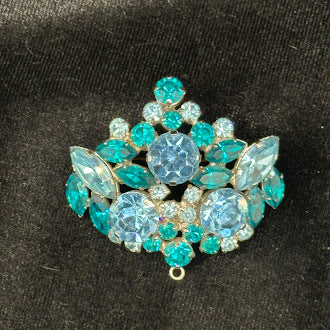 Silver-tone brooch pendant marked Austria with light blue and teal rhinestones, view 5