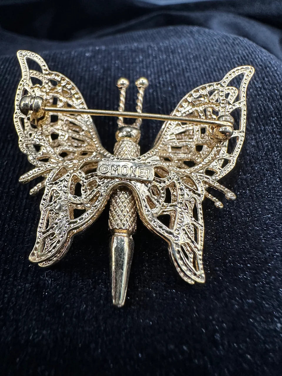 Signed Monet gold-tone openwork butterfly brooch with textured filigree-style wings, view 4