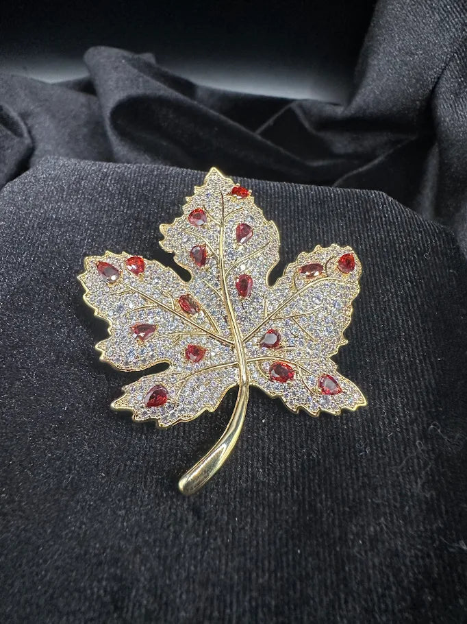 Gold-tone rhinestone maple leaf brooch with red-orange accent stones, view 2