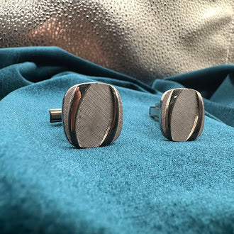 Vintage silver tone oval tie tack set with brushed textured panel design and chain back