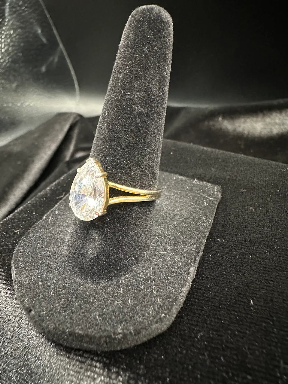 Gold-tone solitaire ring with large pear-shaped clear crystal in raised prong setting, view 3