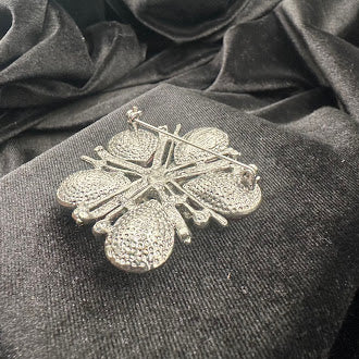 Silver-tone flower brooch with pink teardrop crystal petals and radiating bars, view 5